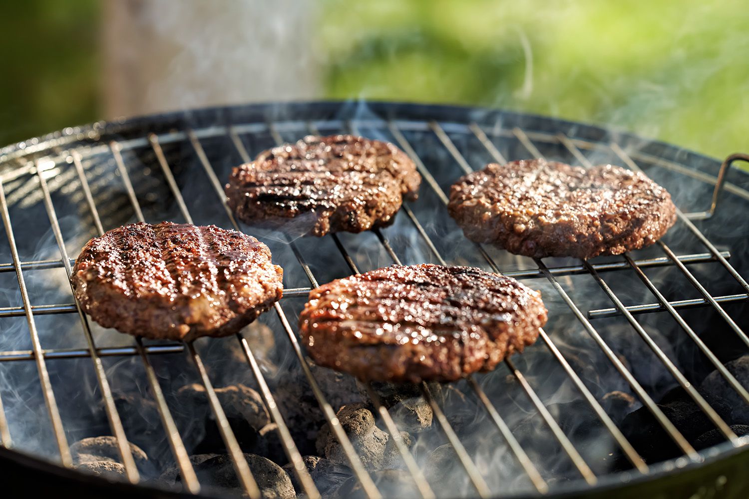 Hamburger or burger patties on a charcoal grill