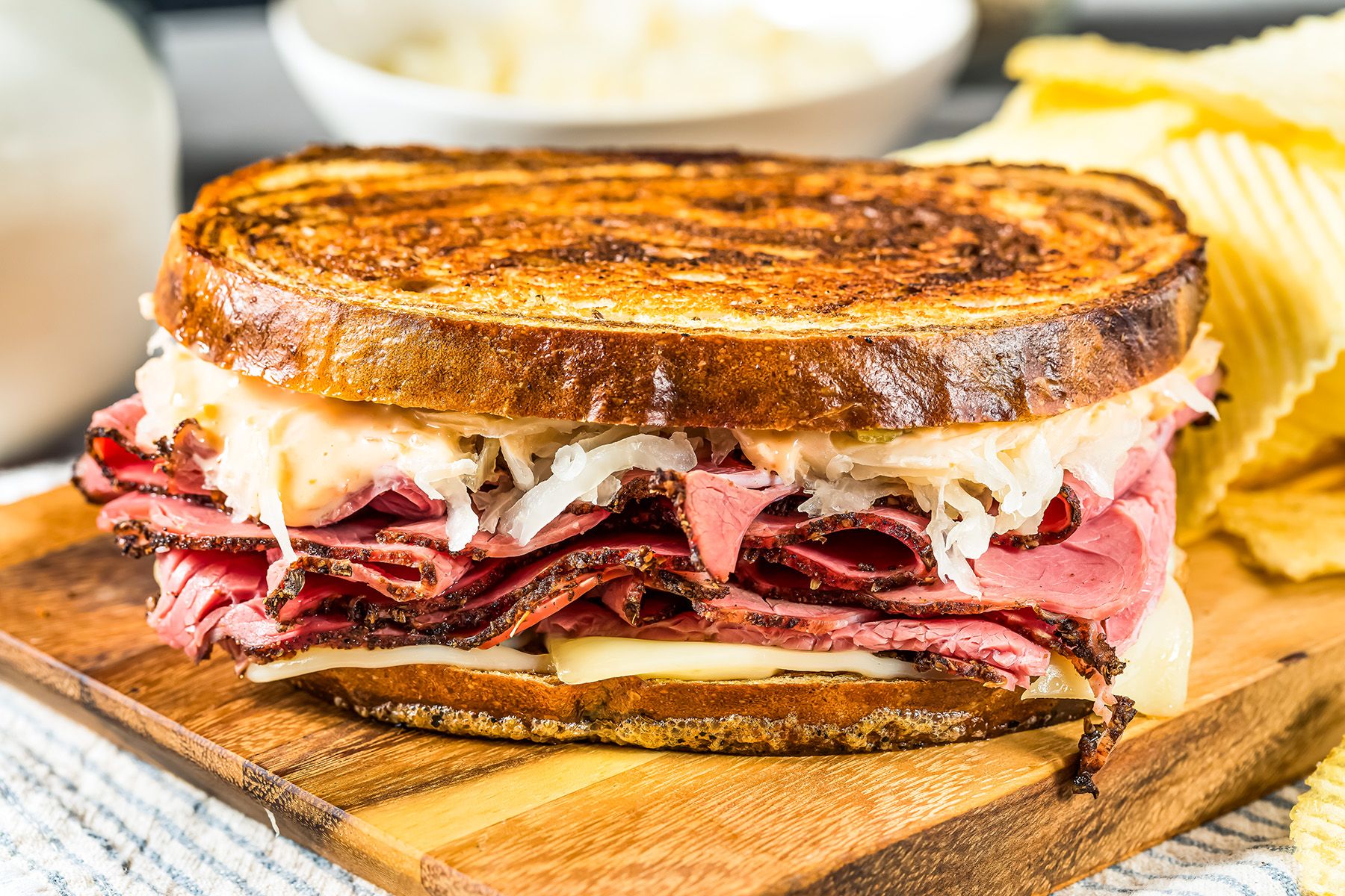 A reuben sandwich on a wooden cutting board