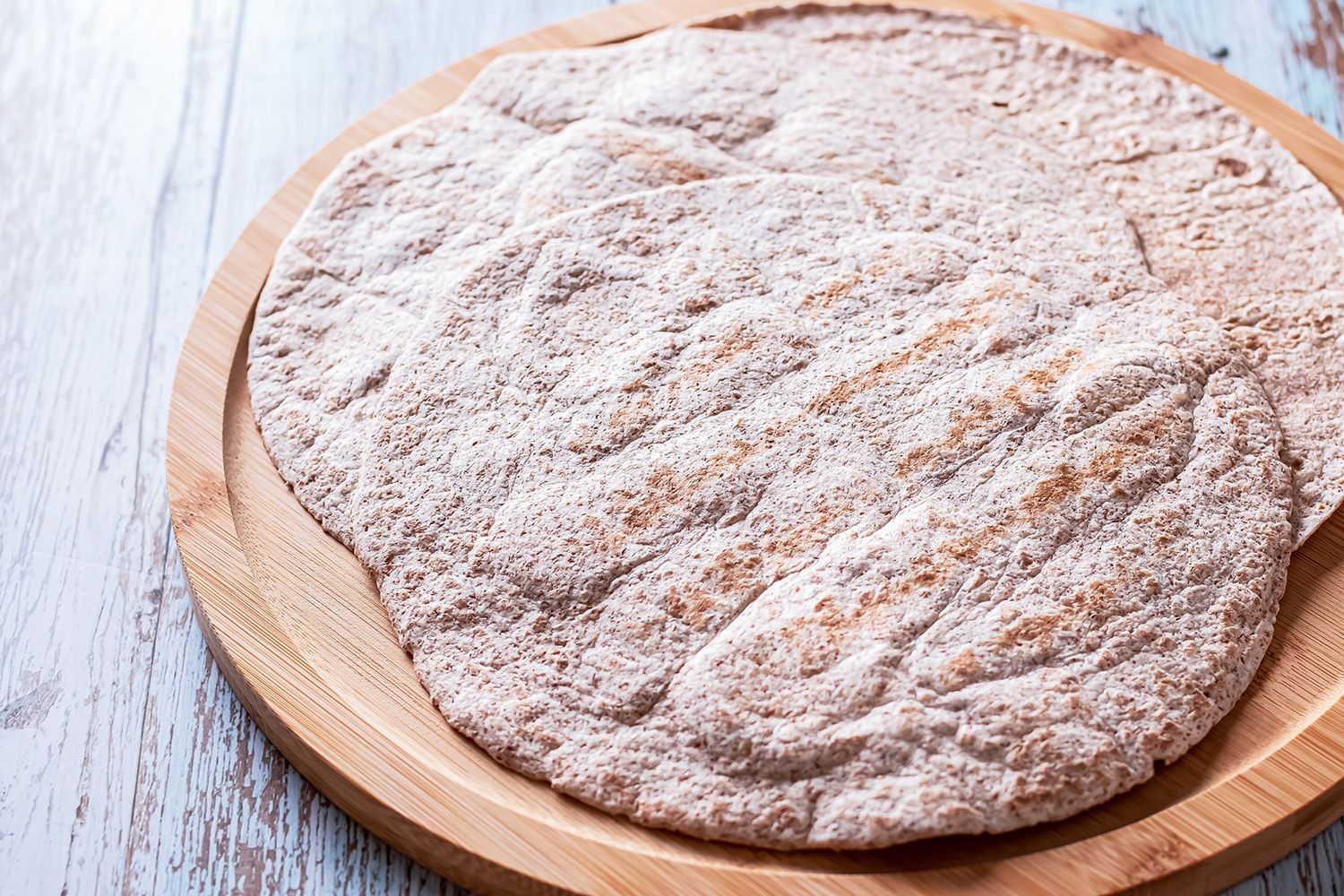 tortillas on a wooden board for making sandwiches, burritos or quesadillas