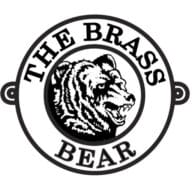 The Brass Bear Delicatessen logo: a round black-and-white badge with a bear's head and the words The Brass Bear