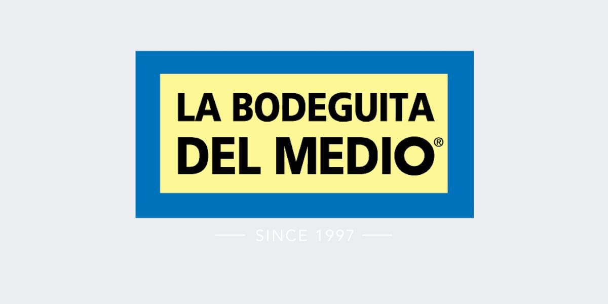 La Bodeguita del Medio wordmark, black letters on yellow inside a blue border, with the line Since 1997