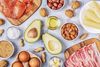 a vast assortment of fatty foods, including avocados, eggs, almonds, salmon, butter, and bacon