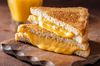 a melty, gooey, delicious grilled cheese sandwich with cheddar cheese and american cheese
