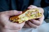 Holding a sandwich in two hands as an example of human-centered design in sandwiches