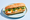 A bánh mì on a pale blue plate, the baguette split lengthways to show fried egg with shredded pickled carrot, cucumber, coriander and lettuce.