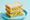 Two halves of an egg sandwich stacked on a blue plate, white bread around a thick layer of sieved egg scattered with chopped chives.