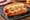 Kansas City reuben dog: a grilled hot dog in a bun topped with sauerkraut, melted Swiss cheese and Thousand Island dressing.