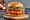 Mom’s Touch Psy Thigh Burger: a whole hand-battered fried chicken thigh on a toasted sesame bun with lettuce, onion and pickles.