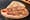 A folded piadina romagnola filled with thick slices of mortadella.