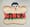 Dino's painted wooden sign on a wall: a smiling cartoon sub roll with red Dino's lettering and green lettuce