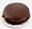 A glossy chocolate Sacher torte piped with the word Sacher, edged with chocolate shavings, on a paper doily