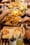 Shawarma fries, rolled wraps, hummus and grilled pita on branded paper-lined trays, hands reaching in