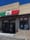 Storefront with a green, white and red banner reading La Bodeguita Panino, lit OPEN signs in the door and window