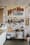 Brick wall inside the bakery with a painted West Won Bread sign, a shelf of books and a pizza peel below