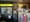 Inside Flamin Dogs Deli: a yellow sign above a drinks cooler, an ATM and a rack of snacks at the counter