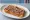 Anchovy Toast: an illustration of anchovy and butter on white bread.
