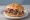Arby's Classic Roast Beef: an illustration of beef, bbq sauce and horseradish on burger bun.