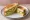 Avocado Sandwich: an illustration of avocado on white bread.