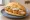 Backfisch Brötchen: an illustration of fish, remoulade, mayonnaise, pickle and more on kaiser roll.