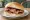 Bacon Batch: an illustration of bacon, butter, brown sauce and ketchup.