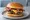 Bacon Cheeseburger: an illustration of beef, bacon and american cheese on burger bun.