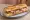 Baguette Garnie: an illustration of ham, butter and pickle on baguette.