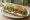 Baguette Vegetarian (באגט צמחוני): an illustration of cheese, tomato, cucumber and lettuce on baguette.
