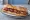 Baguette with Pastrami (באגט עם פסטרמה): an illustration of pastrami and mustard on baguette.