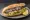 Balık Ekmek Karaköy: an illustration of onion, lettuce and lemon on bread.
