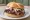 Baltimore Pit Beef: an illustration of beef, horseradish and onion on kaiser roll.
