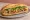 Bánh Mì 25: an illustration of pork, pâté, đồ chua, cilantro and more on bánh mì baguette.