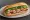 Bánh Mì Đám Giỗ: an illustration of pork, đồ chua, cilantro, cucumber and more on bánh mì baguette.