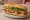 Bánh Mì (American): an illustration of pork, pâté, đồ chua, cilantro and more on baguette.