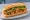 Bánh Mì Đậu Hũ Kho: an illustration of tofu, caramel sauce, đồ chua, cilantro and more on bánh mì baguette.