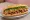Bánh Mì Ba Chỉ Nướng: an illustration of pork belly, đồ chua, cilantro, cucumber and more on bánh mì baguette.