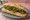 Bánh Mì Bò Nướng Lá Lốt: an illustration of beef, mayonnaise, đồ chua, cucumber and more on bánh mì baguette.