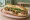 Bánh Mì Bún Thịt Nướng: an illustration of pork, mayonnaise, đồ chua, cucumber and more on bánh mì baguette.