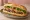Bánh Mì Burger: an illustration of beef, mayonnaise, đồ chua, cucumber and more on bánh mì baguette.