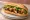 Bánh Mì Cá Kho: an illustration of fish, fish sauce, caramel sauce, mayonnaise and more on bánh mì baguette.