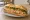 Bánh Mì Cá Ngừ Spicy Mayo: an illustration of tuna, mayonnaise, sriracha, đồ chua and more on bánh mì baguette.