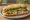 Bánh Mì Cá Nướng: an illustration of fish, mayonnaise, đồ chua, cucumber and more on bánh mì baguette.