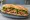 Bánh Mì California: an illustration of pork, mayonnaise, đồ chua, cucumber and more on bánh mì baguette.