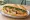 Bánh Mì Chả Cá: an illustration of fish, đồ chua, cucumber, cilantro and more on bánh mì baguette.
