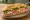 Bánh Mì Chả Lụa Đặc Biệt: an illustration of pork, chả lụa, pâté, đồ chua and more on bánh mì baguette.