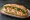 Bánh Mì Cua: an illustration of crab, đồ chua, cucumber, cilantro and more on bánh mì baguette.