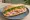 Bánh Mì Cưới: an illustration of pork, pâté, đồ chua, cucumber and more on bánh mì baguette.