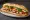 Bánh Mì Đêm: an illustration of pork, đồ chua, cucumber, cilantro and more on bánh mì baguette.