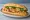 Bánh Mì Gà Chay: an illustration of mock meat, đồ chua, cucumber, cilantro and more on bánh mì baguette.