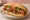 Bánh Mì Gà Rán Kiểu Hàn: an illustration of chicken, gochujang, đồ chua, cucumber and more on bánh mì baguette.