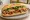 Bánh Mì Gà Teriyaki: an illustration of chicken, maggi seasoning sauce, đồ chua, cucumber and more on bánh mì baguette.